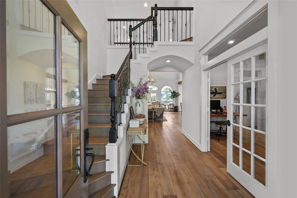 Step inside and you are greeted with an inviting open layout with high ceilings, elegant archways, and an abundance of natural light. The flooring is composed of rich, warm-toned engineered French Oak wood adding a sense of sophistication and warmth to the interior and leads into a spacious living area.