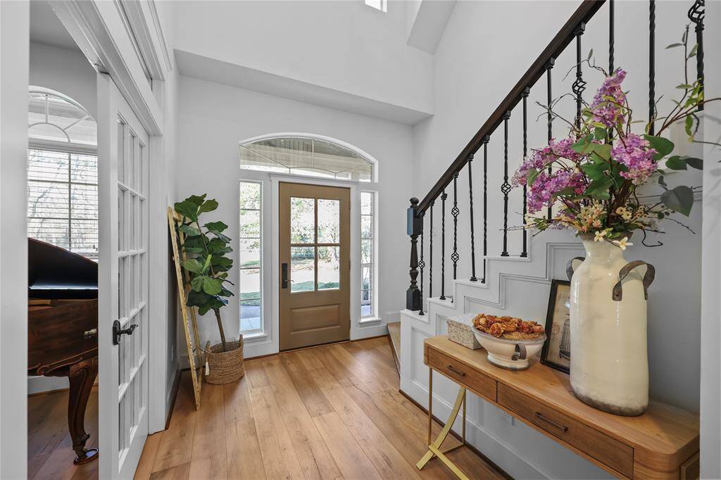 A reverse look at the stunning entryway.  The sidelight windows surrounding the door allow the natural light to filter in complimenting the door with a large picture frame glass inlay.