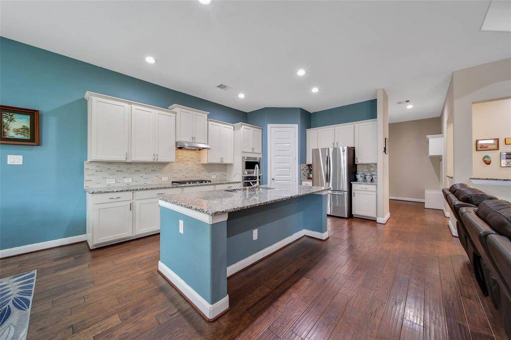 With a reverse osmosis purified drinking water tap, abundant cabinet space, and a walk-in pantry this kitchen is beautiful and functional.