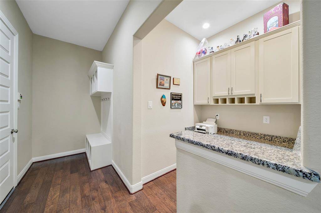 The storage locker and hooks is conveniently located at the 3-car garage entry and the study nook is great for working from home or organization.