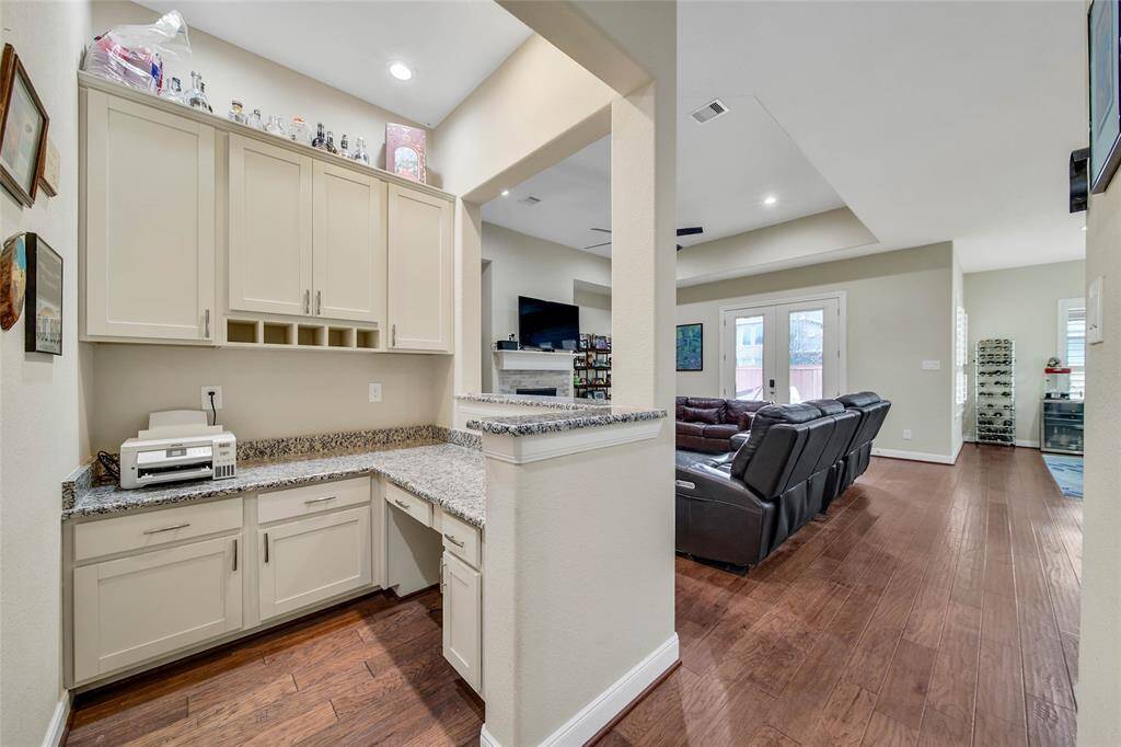 A built-in desk with wrap around cabinets makes this space functional with plenty of counter space and storage and a great place for the kids to complete their homework assignments.