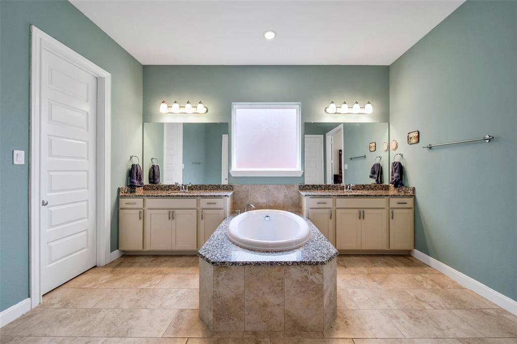 The en'suite bath is spectacular with dual vanities and a center soaking tub.