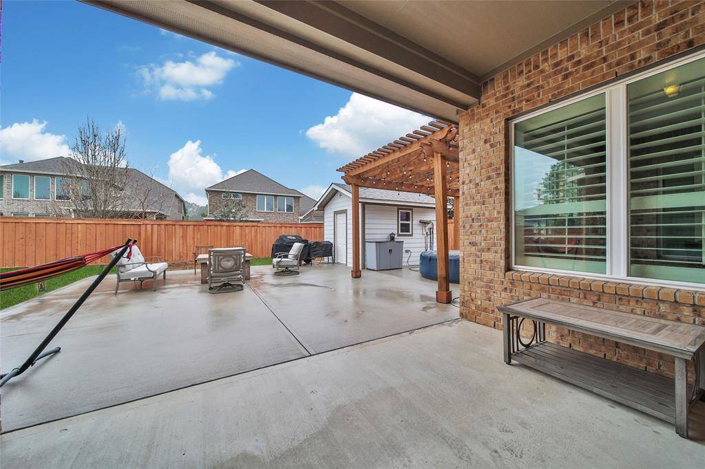 The oversized covered patio is just the start of this awesome backyard.