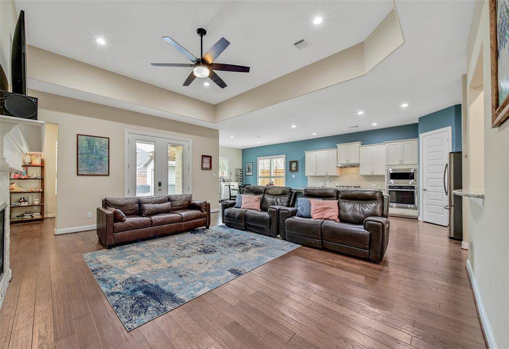 Wood flooring, plantation shutters, and a spacious, open floorplan make this a home ideal for entertaining.