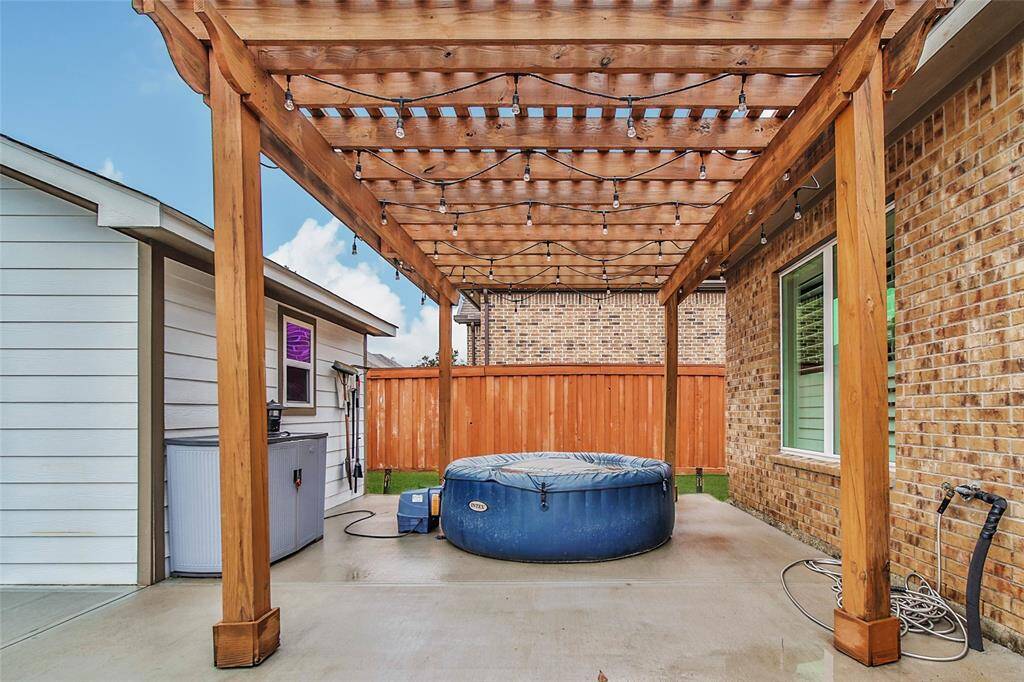 The pergola adds a little shade and an easy way to string lights across this area of the patio