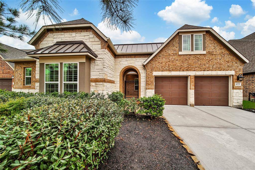 The brick and stone elevation is beautiful with a gated entry leading to the private courtyard.