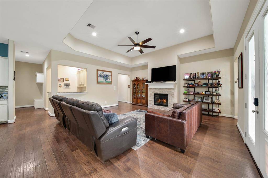 The remote-controlled gas-log fireplace with bookcase niches on either side is the focal point of the room.