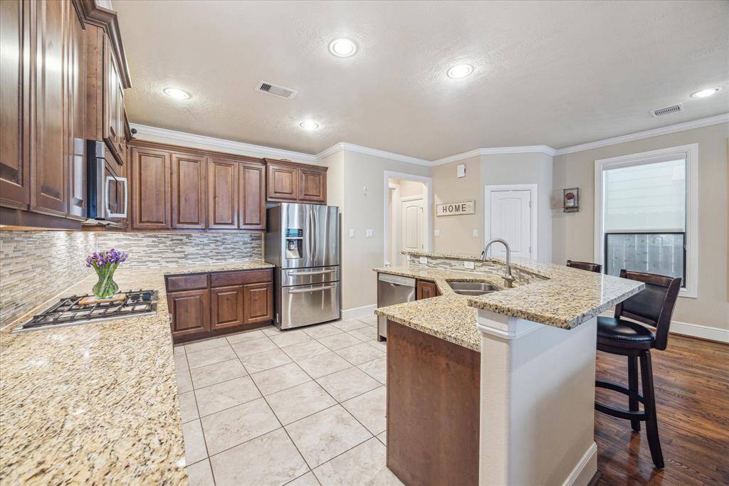 he generously sized kitchen offers granite countertops, ample cabinetry for your cookware and dishes, a gas range with cooktop, and stainless steel appliances. The refrigerator is included.