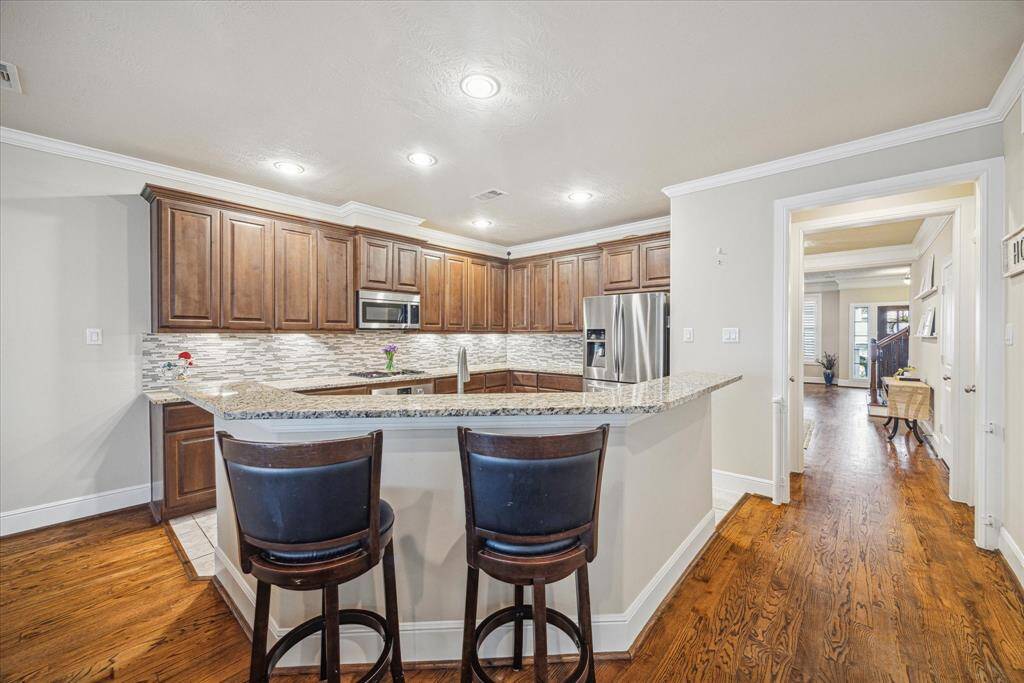 Another view of the kitchen highlighting the large breakfast bar.