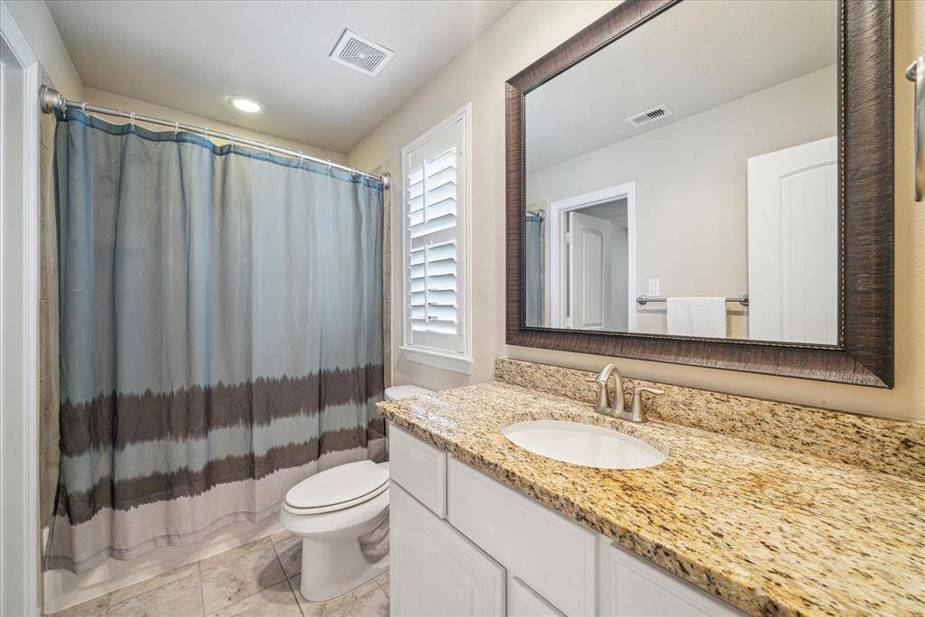 The two secondary bedrooms share a Hollywood bathroom featuring a shower/tub combination.