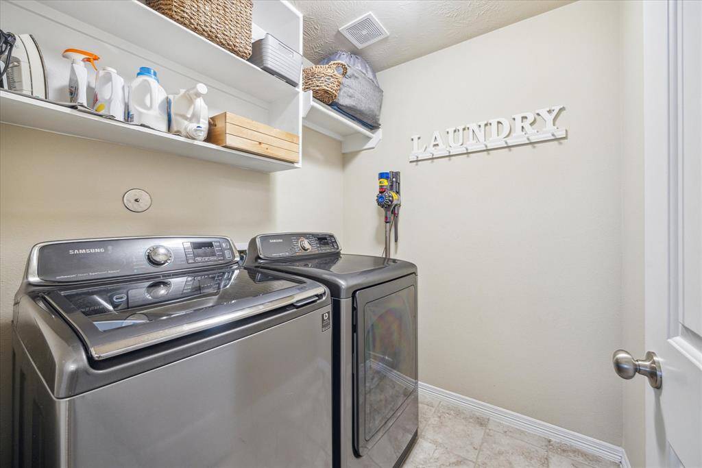 An upstairs utility room enhances daily convenience.