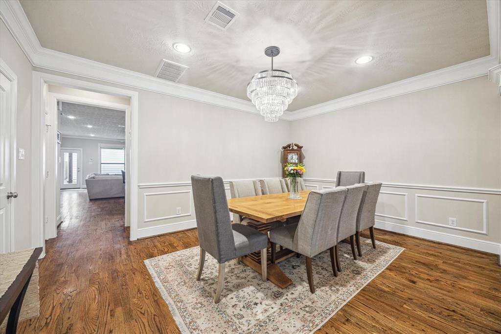 The dining room showcases timeless elegance with its classic millwork and stunning chandelier.