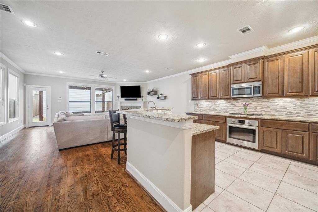 First-floor living at its finest! The open floor plan seamlessly connects the kitchen and family room, creating the perfect space for quality family time and entertaining guests.