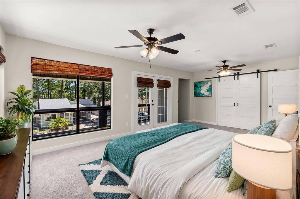 Virtually staged - The primary bedroom is bright and airy, with large windows providing ample natural light and walks out to a private balcony