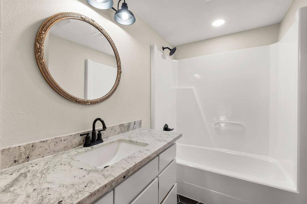The primary bathroom includes a tub and shower combination