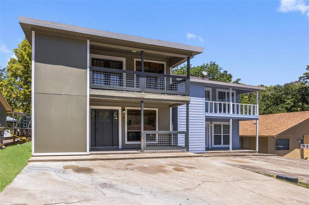 The home has a cute front porch and driveway parking for two vehicles