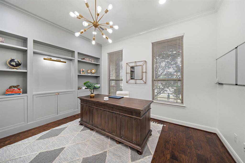 A dedicated study complete with built in book shelving, lighting and french doors.