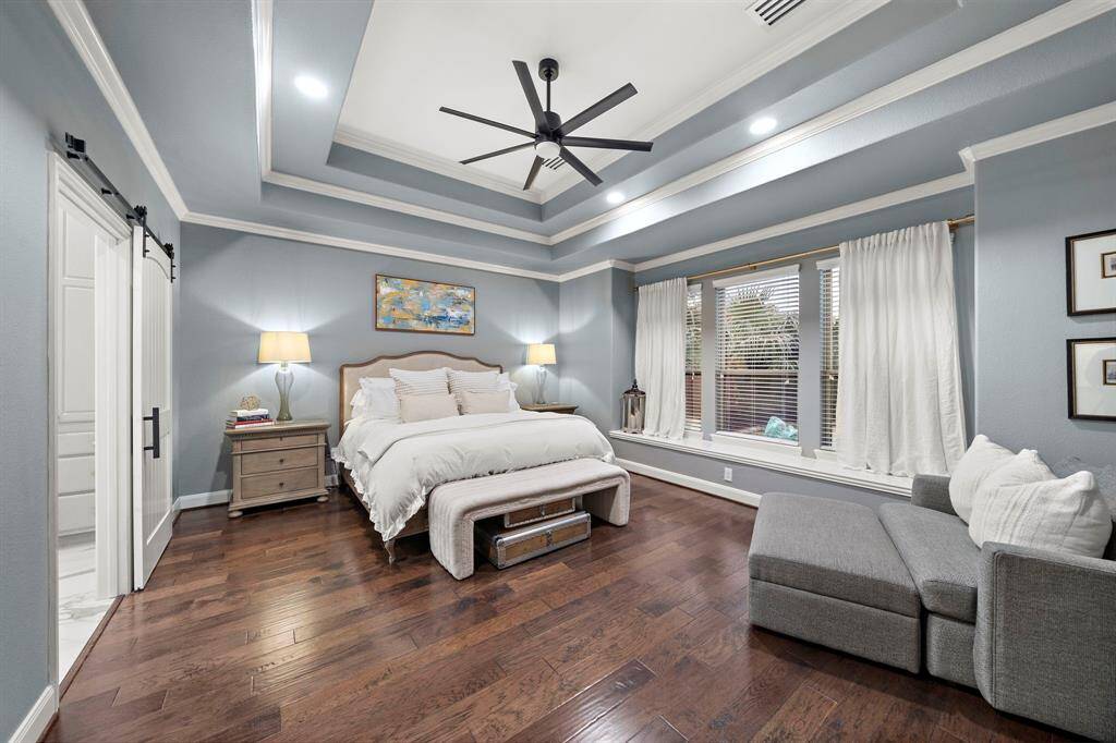 The primary suite is a spa-like retreat featuring an oversized shower, soaking tub, custom vanity as well as dream custom walk-in closet.