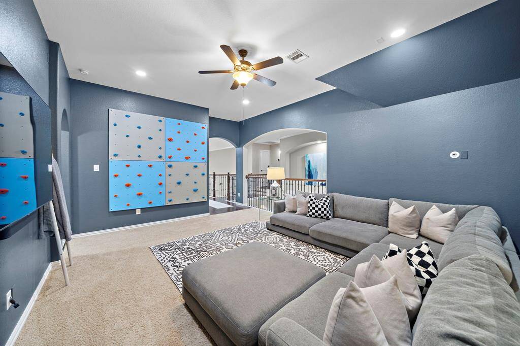 The second floor provides a built-in desk area, large game room and storage galore.