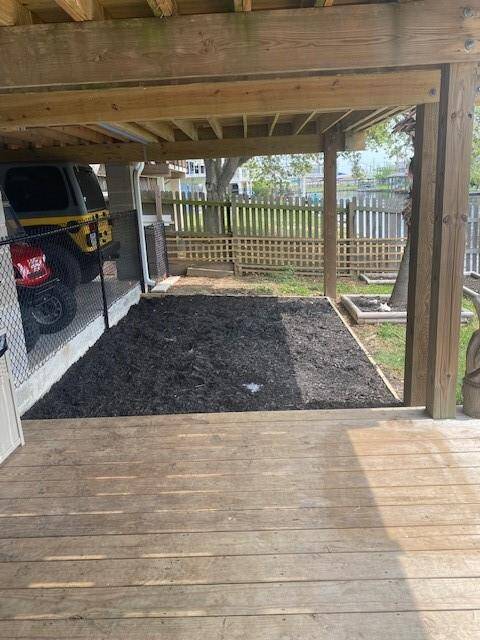Covered patio on the back of the house with  play area for the kids.