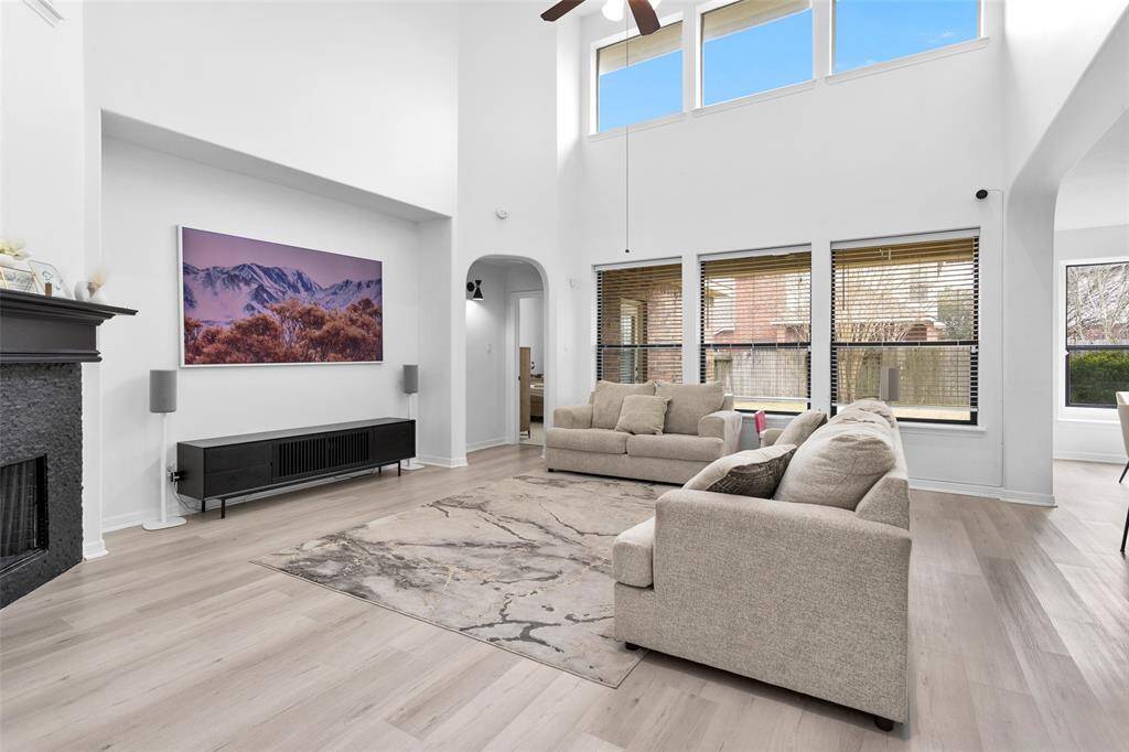 The living space provides high ceilings with a wall of windows offering an abundance of natural light.