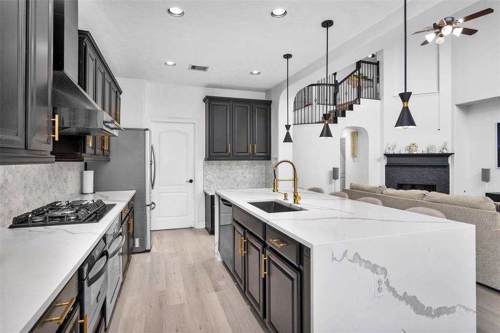The quartz countertops and gold accents bring the custom details into the kitchen.
