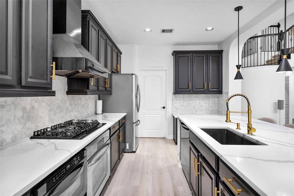 Custom backsplash and stainless steel appliances.