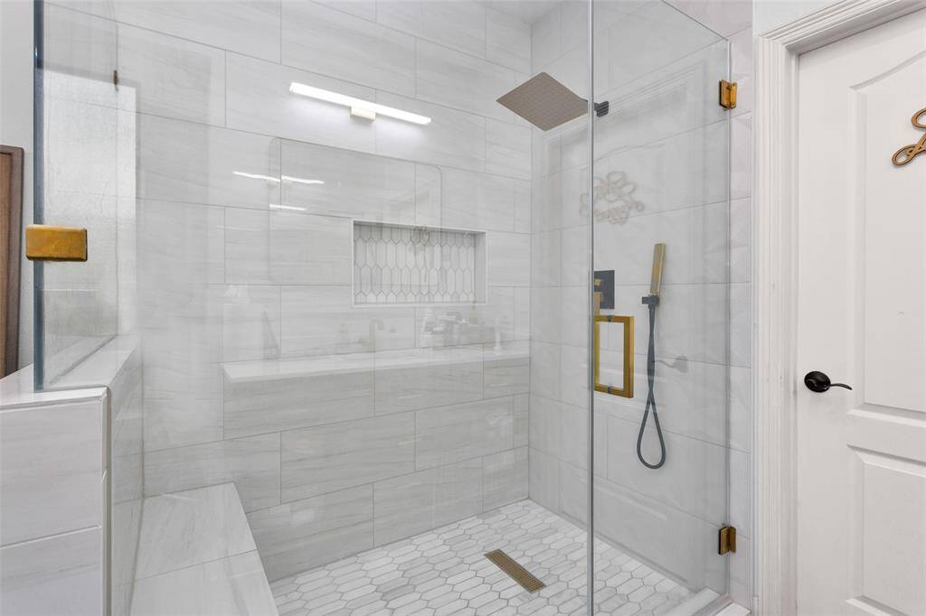 Custom shower with shower bench and rainfall shower head.
