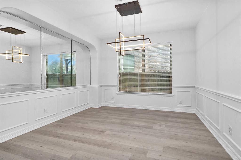 The formal dining room is light and bright with updated light fixture.