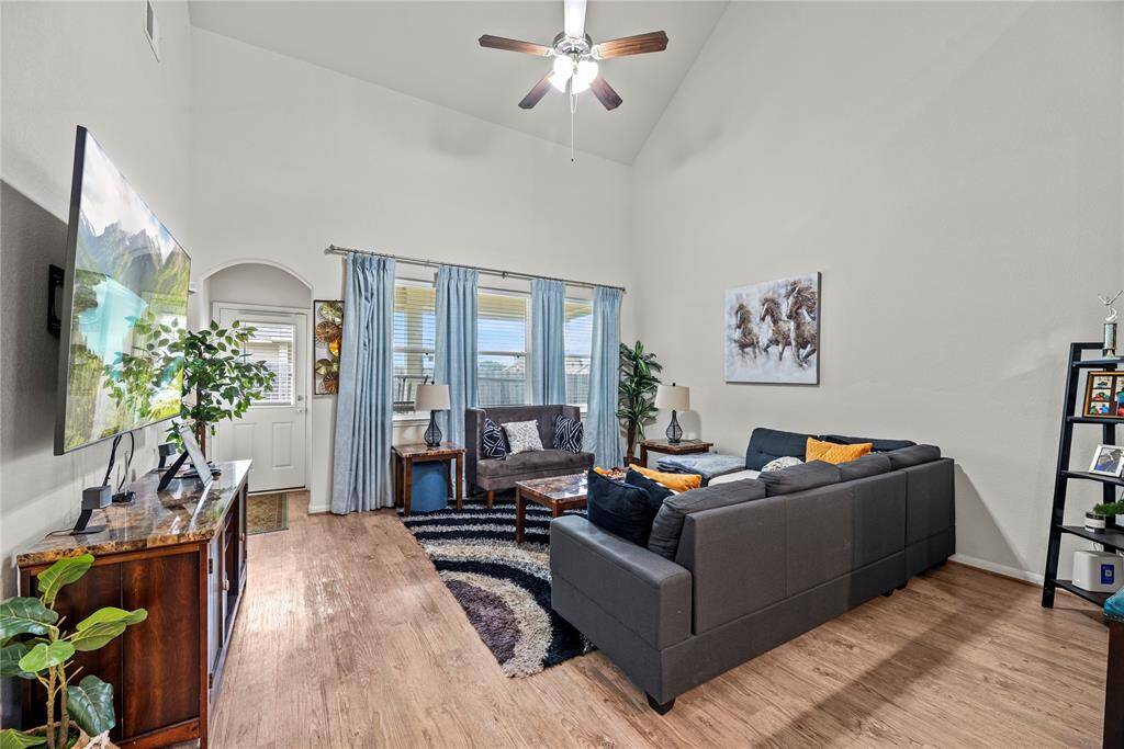 This chic living room space has a great feel with tons of natural light coming from the wall of windows.