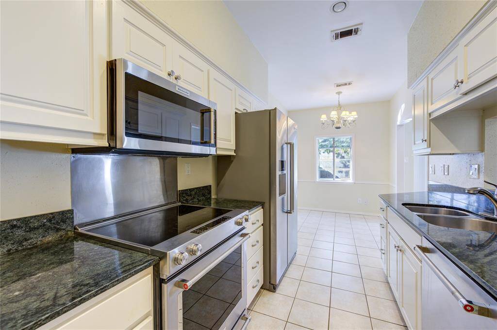 Discover the kitchen's sleek design, featuring modern appliances and abundant natural light.