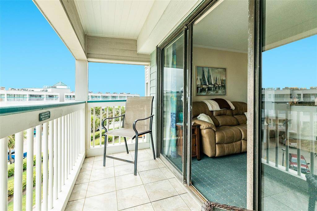 Looking inside the condo from the balcony. Recently installed storm shutters.