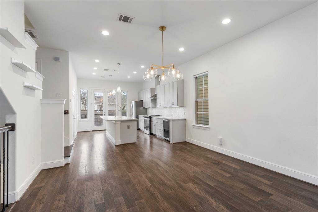 Gorgeous hardwoods throughout, amazing light coming through all the windows & a great open floor plan. There are window coverings on all windows for privacy. They simply pull down when you need them.