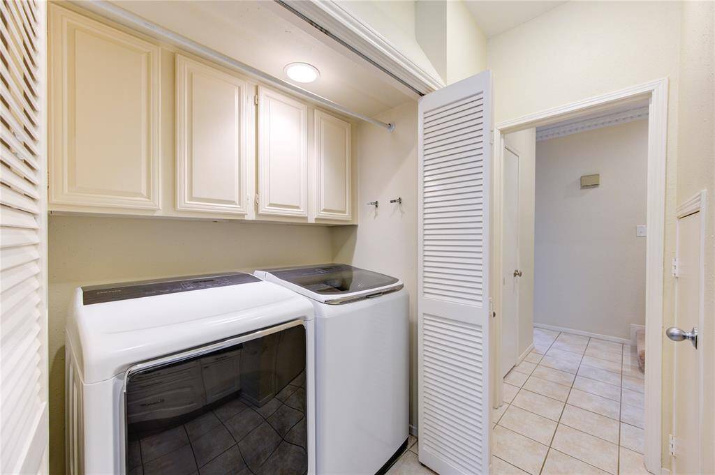 Convenient in-kitchen laundry area, discreetly tucked behind an accordion door.
