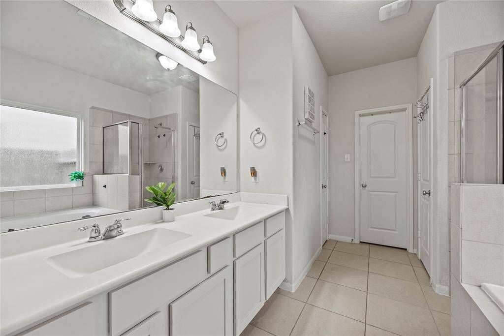 Dual vanities in your primary bath, offer personal space with tons of dedicated cabinet space. Pristine white palette elevates every detail.