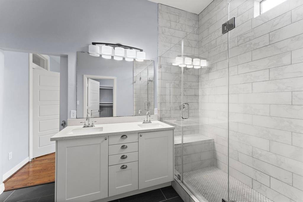 View of the vanity with double sinks and drawers.