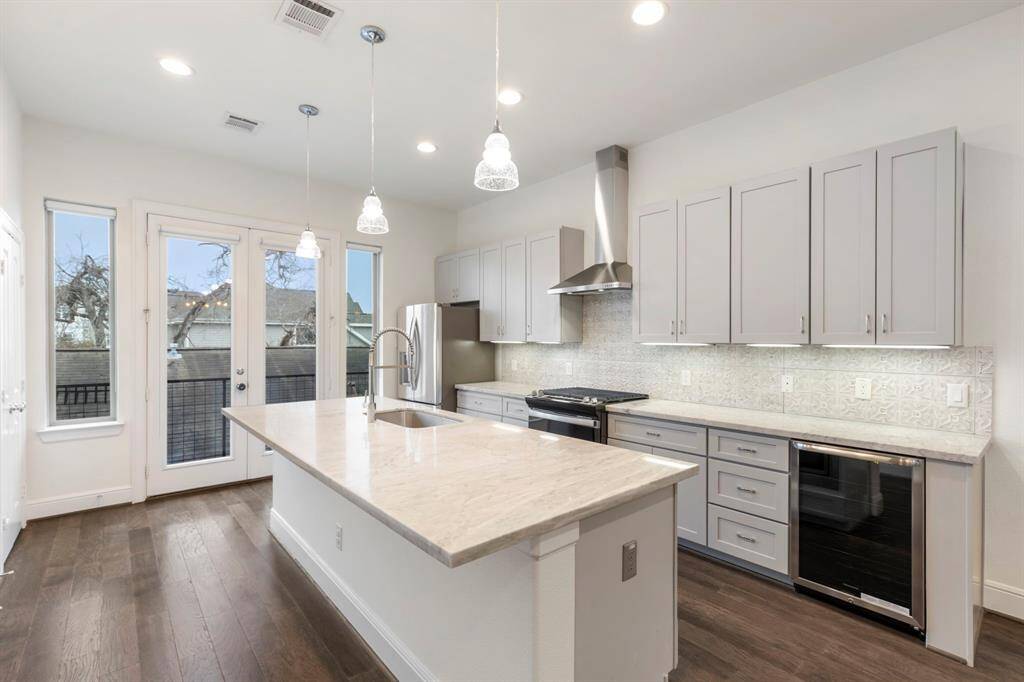 This kitchen is a chef's dream come true featuring a new stove/oven, wine fridge, & lots of cabinet & countertop space.