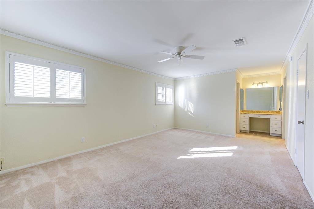 Expansive primary bedroom with a charming vanity area, perfect for relaxation and convenience.