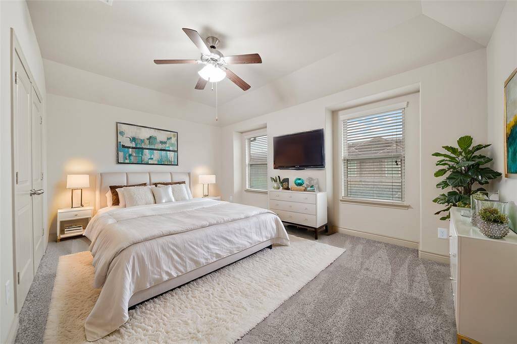 Secondary bedroom upstairs with carpet, a ceiling fan, high ceilings and a spacious closet!