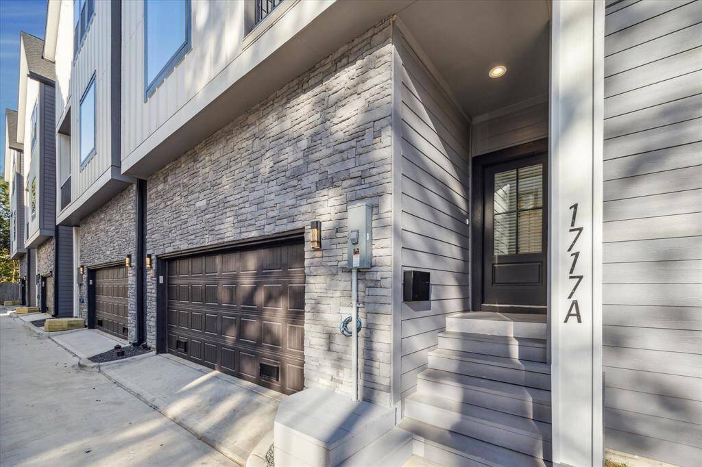 A stunning stonework exterior graces the front facade of this home, inviting guests and residents to enjoy the welcoming ambiance of the covered front porch.