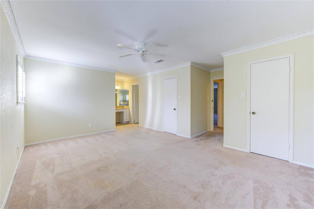 Spacious primary bedroom with ample natural light and direct bathroom access.