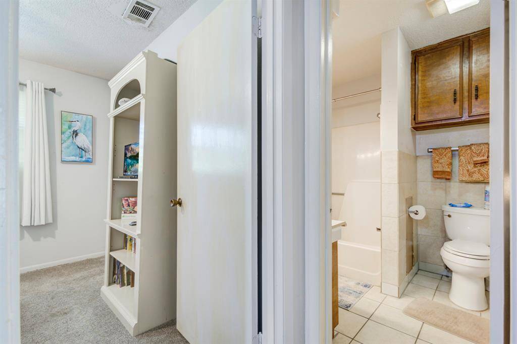 Entrance from hallway into the full bathroom on the right or the second bedroom