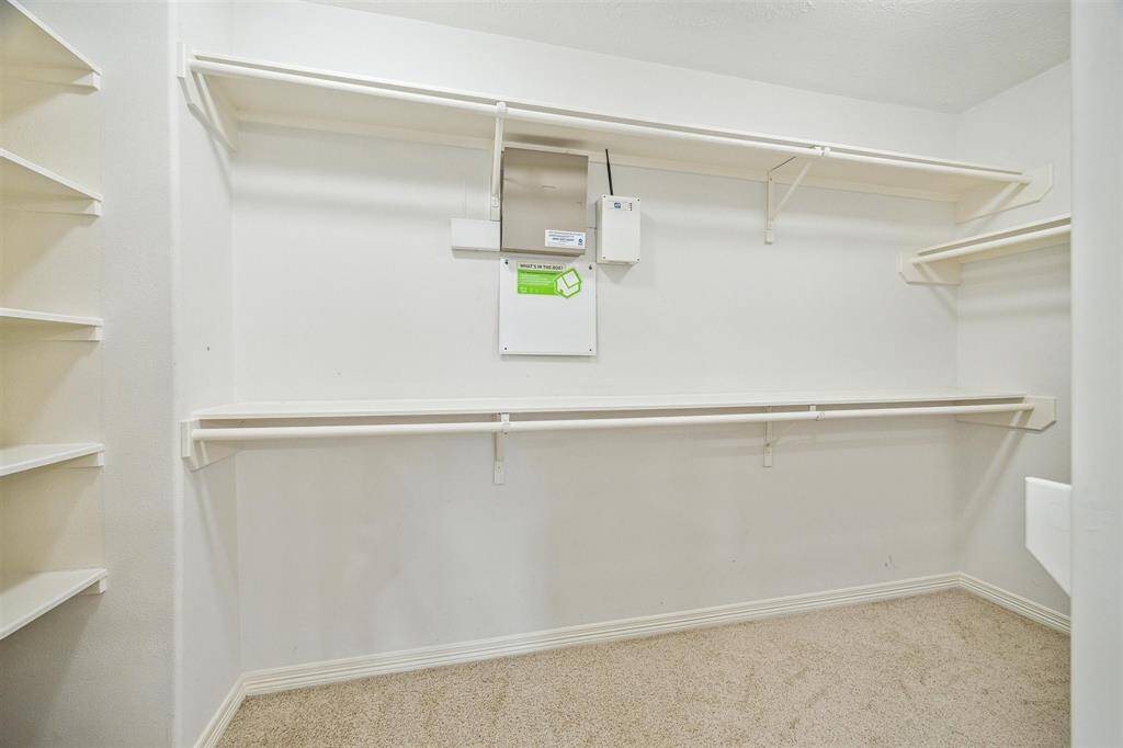 Spacious primary walk-in closet.