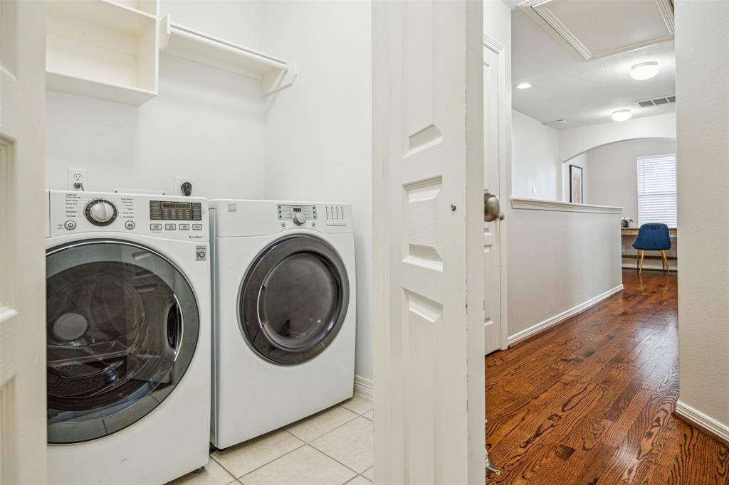 Convenient third-floor laundry with built-in shelving and space for full-size washer & dryer.