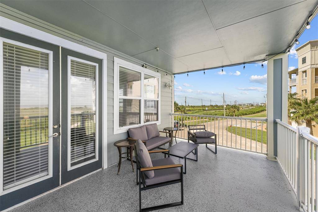 This spacious balcony offers a comfortable outdoor seating area with stylish patio furniture, perfect for enjoying the serene view. The covered space allows for year-round use, making it an ideal spot for relaxation and entertaining.