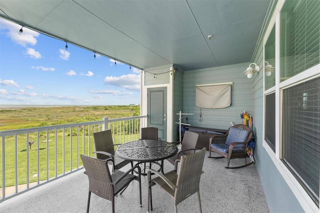 Start your day with a coffee on the oversized covered balcony overlooking the bay and nature reserve, and unwind in the evening with a game on the outdoor flatscreen TV.
