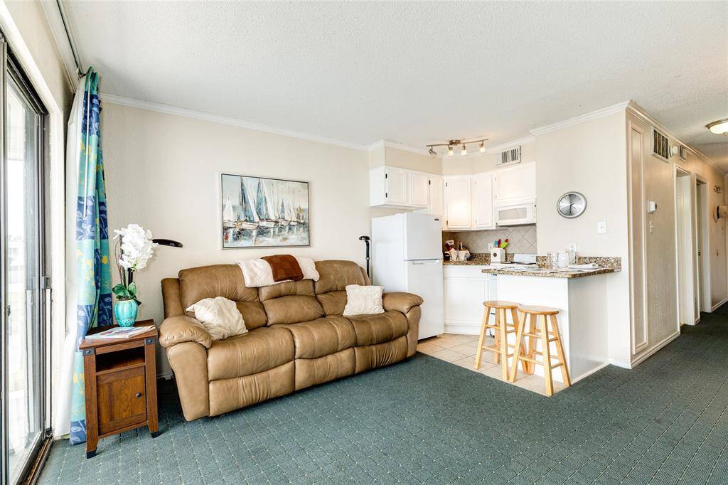 Living and kitchen area with breakfast bar.