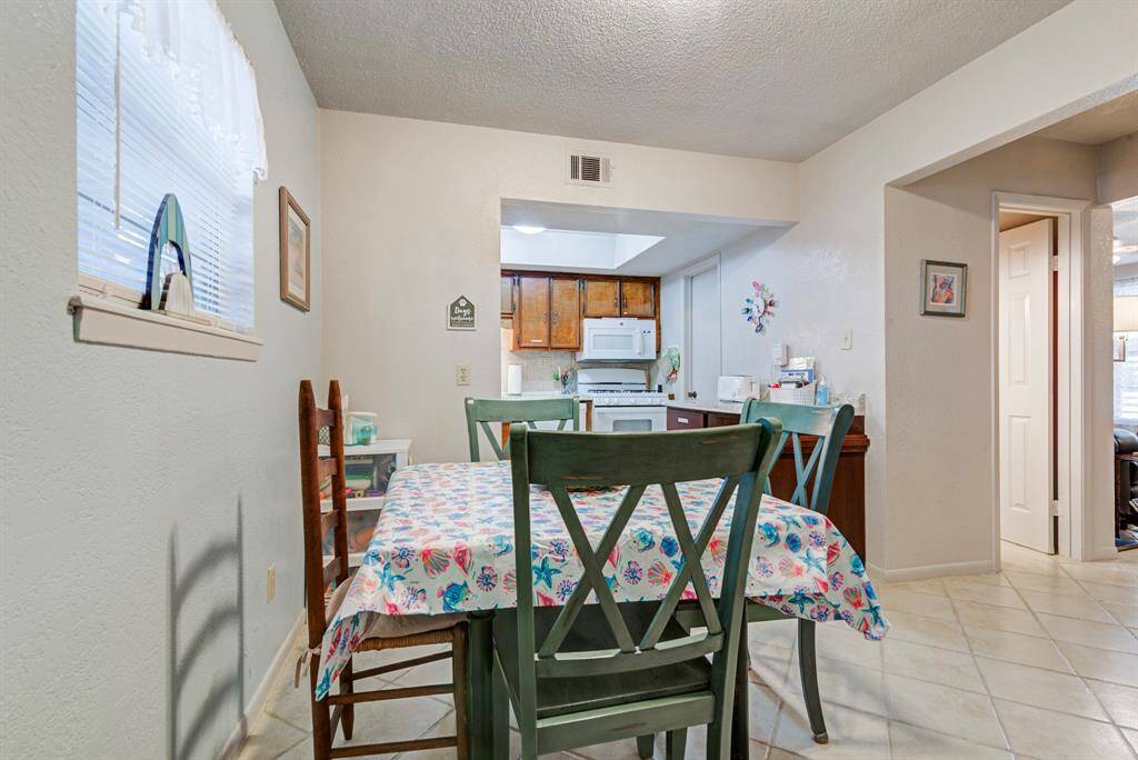 Entrance from the garage into the dining room, kitchen ahead and half bathroom through the door on the right.