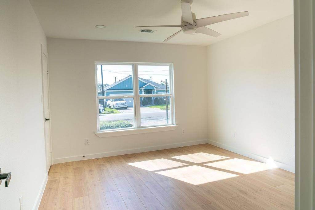 Bright bedroom with new windows, offering ample natural light and plenty of space.