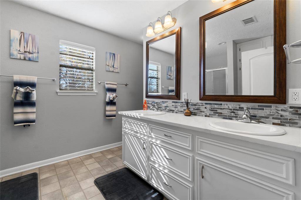 Primary bathroom with quartz counters and double sinks